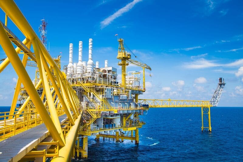 Yellow oil platform in vast blue sea