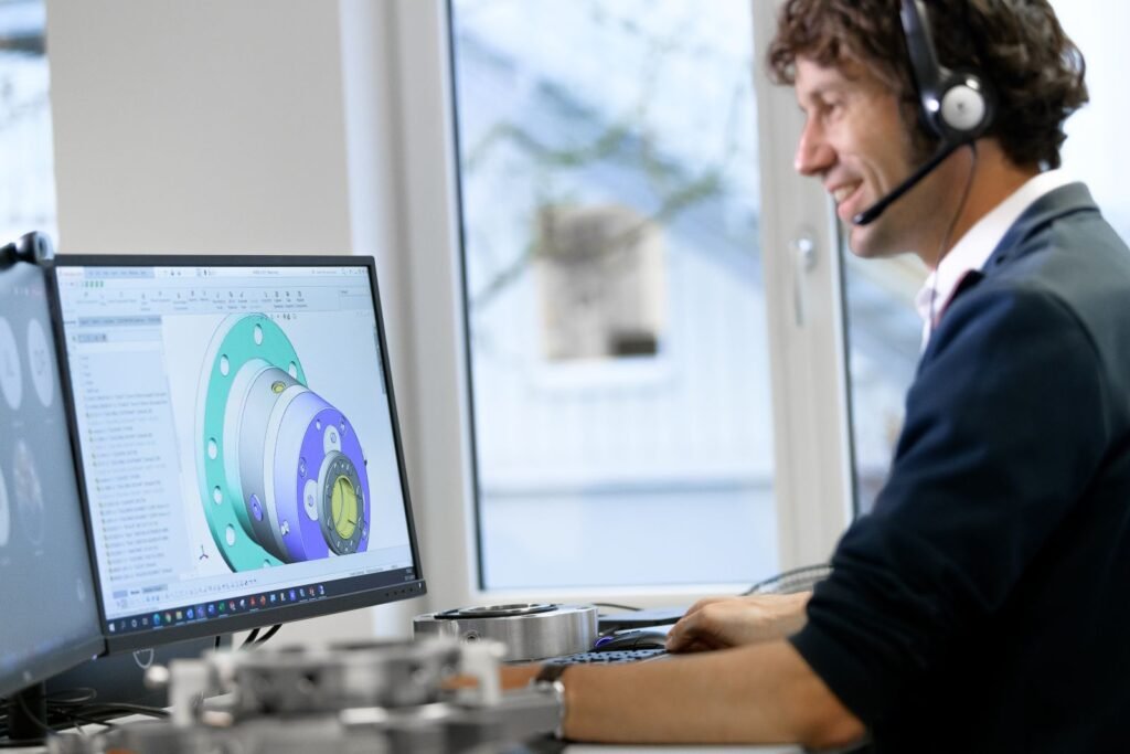 Chesterton engineer wearing a headset reviewing a mechanical seal assembly in CAD software while consulting with a customer